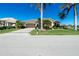 Front view of a single-story house with a two-car garage and mature landscaping at 1110 Rum Cay Ct, Punta Gorda, FL 33950