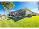 Single-story house with lanai, lush landscaping, and a canal view at 1110 Rum Cay Ct, Punta Gorda, FL 33950