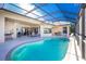 Relaxing pool area with covered patio and grill at 1110 Rum Cay Ct, Punta Gorda, FL 33950