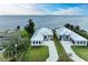 Two modern waterfront homes with metal roofs and attached garages at 112 Northshore Ter, Punta Gorda, FL 33980