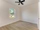 Well-lit bedroom featuring wood-look tile floors and a ceiling fan at 112 Northshore Ter, Punta Gorda, FL 33980