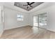 Bedroom with hardwood floors, ceiling fan and sliding glass doors to patio at 112 Northshore Ter, Punta Gorda, FL 33980