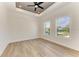 Bright bedroom with wood-look tile flooring and tray ceiling at 112 Northshore Ter, Punta Gorda, FL 33980