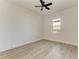 Bright bedroom with wood-look tile floor, ceiling fan, and large window at 112 Northshore Ter, Punta Gorda, FL 33980