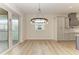 Dining room features a circular chandelier and hardwood floors at 112 Northshore Ter, Punta Gorda, FL 33980