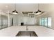 Kitchen island with quartz countertop and breakfast bar overlooking the living room at 112 Northshore Ter, Punta Gorda, FL 33980