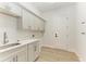 Laundry room with light gray cabinets, quartz countertops, and built-in storage at 112 Northshore Ter, Punta Gorda, FL 33980