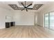 Bright living room with high ceilings, wood-look floors, and sliding glass doors at 112 Northshore Ter, Punta Gorda, FL 33980