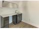 Modern wet bar with quartz countertop, wine rack, and dark cabinetry at 112 Northshore Ter, Punta Gorda, FL 33980