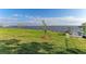 Waterfront view with lush grass and young trees at 116 Northshore Ter, Punta Gorda, FL 33980