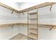 Large walk-in closet featuring built-in shelves and rods at 116 Northshore Ter, Punta Gorda, FL 33980