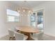 Light and airy dining area with oval wood table and modern chandelier at 116 Northshore Ter, Punta Gorda, FL 33980