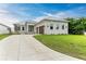 Modern home with attached two-car garage, metal roof, and landscaping at 116 Northshore Ter, Punta Gorda, FL 33980