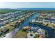 Bird's-eye view of waterfront community showcasing a canal-front house at 1245 Whippoorwill Ct, Punta Gorda, FL 33950