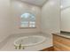 Bathroom with oval soaking tub and granite countertop at 1245 Whippoorwill Ct, Punta Gorda, FL 33950