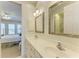 Elegant bathroom with double vanity and a view into the bedroom at 1245 Whippoorwill Ct, Punta Gorda, FL 33950