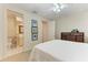 Well-lit bedroom with a comfortable bed and adjacent bathroom at 1245 Whippoorwill Ct, Punta Gorda, FL 33950