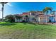 Two-story house featuring a tile roof, palm trees, and a landscaped yard at 1245 Whippoorwill Ct, Punta Gorda, FL 33950