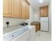 Laundry room with washer, dryer, cabinets, and a sink at 1245 Whippoorwill Ct, Punta Gorda, FL 33950