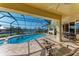 Screened pool and patio furniture overlooking canal at 1245 Whippoorwill Ct, Punta Gorda, FL 33950