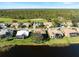 Aerial view of lakefront homes with golf course views at 13761 Long Lake Ln, Port Charlotte, FL 33953