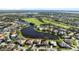 Aerial view of upscale community near golf course and water at 13761 Long Lake Ln, Port Charlotte, FL 33953