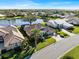 Aerial view of upscale homes near a lake and golf course at 13761 Long Lake Ln, Port Charlotte, FL 33953