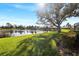 Serene backyard with pond view and lush landscaping at 13761 Long Lake Ln, Port Charlotte, FL 33953