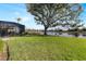 Spacious backyard with pond view and lush lawn at 13761 Long Lake Ln, Port Charlotte, FL 33953