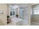 Elegant bathroom with soaking tub, walk-in shower, and modern fixtures at 13761 Long Lake Ln, Port Charlotte, FL 33953