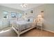 Bedroom with a double bed, window seat, and light-colored furnishings at 13761 Long Lake Ln, Port Charlotte, FL 33953