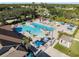 Aerial view of resort-style pool with lounge chairs and umbrellas at 13761 Long Lake Ln, Port Charlotte, FL 33953