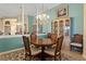 Octagonal dining table with six chairs, situated in a well-lit room at 13761 Long Lake Ln, Port Charlotte, FL 33953