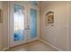 Elegant entryway with glass double doors and niche at 13761 Long Lake Ln, Port Charlotte, FL 33953