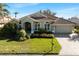 Beautiful home exterior with green walls and tile roof at 13761 Long Lake Ln, Port Charlotte, FL 33953