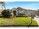 Single story house with a beautiful lawn and driveway at 13761 Long Lake Ln, Port Charlotte, FL 33953