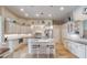 Bright kitchen with island, stainless steel appliances, and white cabinets at 13761 Long Lake Ln, Port Charlotte, FL 33953