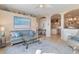 Living room with grey couch and view of kitchen at 13761 Long Lake Ln, Port Charlotte, FL 33953