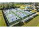 Multiple community pickleball courts in use on a sunny day at 13761 Long Lake Ln, Port Charlotte, FL 33953