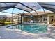 Inviting pool area with covered patio and lush landscaping at 13761 Long Lake Ln, Port Charlotte, FL 33953