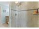 Walk-in shower featuring decorative tile, glass door, and mounted shower head at 13761 Long Lake Ln, Port Charlotte, FL 33953