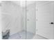 Clean bathroom with a large walk-in shower and marble tile at 1425 Park Beach Cir # 124, Punta Gorda, FL 33950