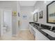 Double vanity, granite countertops and large mirrors in this bathroom at 1531 Aqui Esta Dr # 1, Punta Gorda, FL 33950