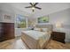 Bright bedroom with king-size bed and plantation shutters at 1531 Aqui Esta Dr # 1, Punta Gorda, FL 33950