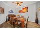 Bright dining area with a wood table and stylish artwork at 1531 Aqui Esta Dr # 1, Punta Gorda, FL 33950