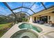 Inviting pool area with spa and screened enclosure at 1531 Aqui Esta Dr # 1, Punta Gorda, FL 33950