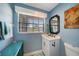 Small bathroom with vanity, toilet, and window at 1573 Faraday St, Port Charlotte, FL 33952