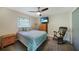 Bright bedroom with a queen bed, rocking chair, and dresser at 1573 Faraday St, Port Charlotte, FL 33952