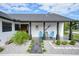 Inviting front porch with stylish seating and landscaping at 1573 Faraday St, Port Charlotte, FL 33952