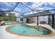 Relaxing kidney-shaped pool with screened enclosure at 1573 Faraday St, Port Charlotte, FL 33952